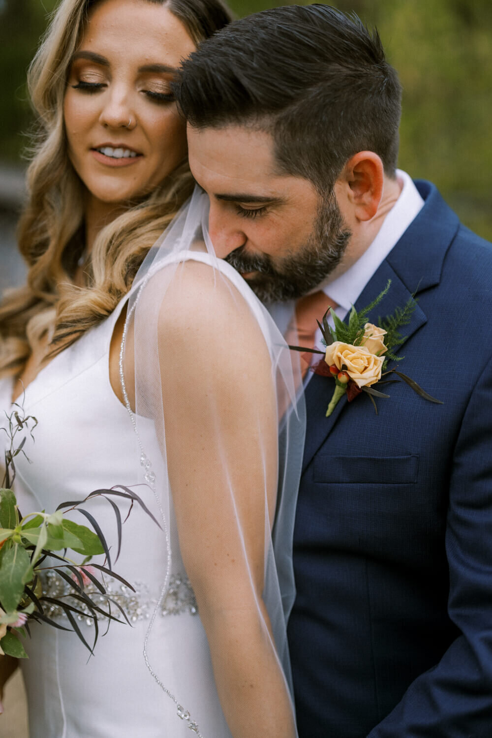 groom-kisses-brides-shoulder