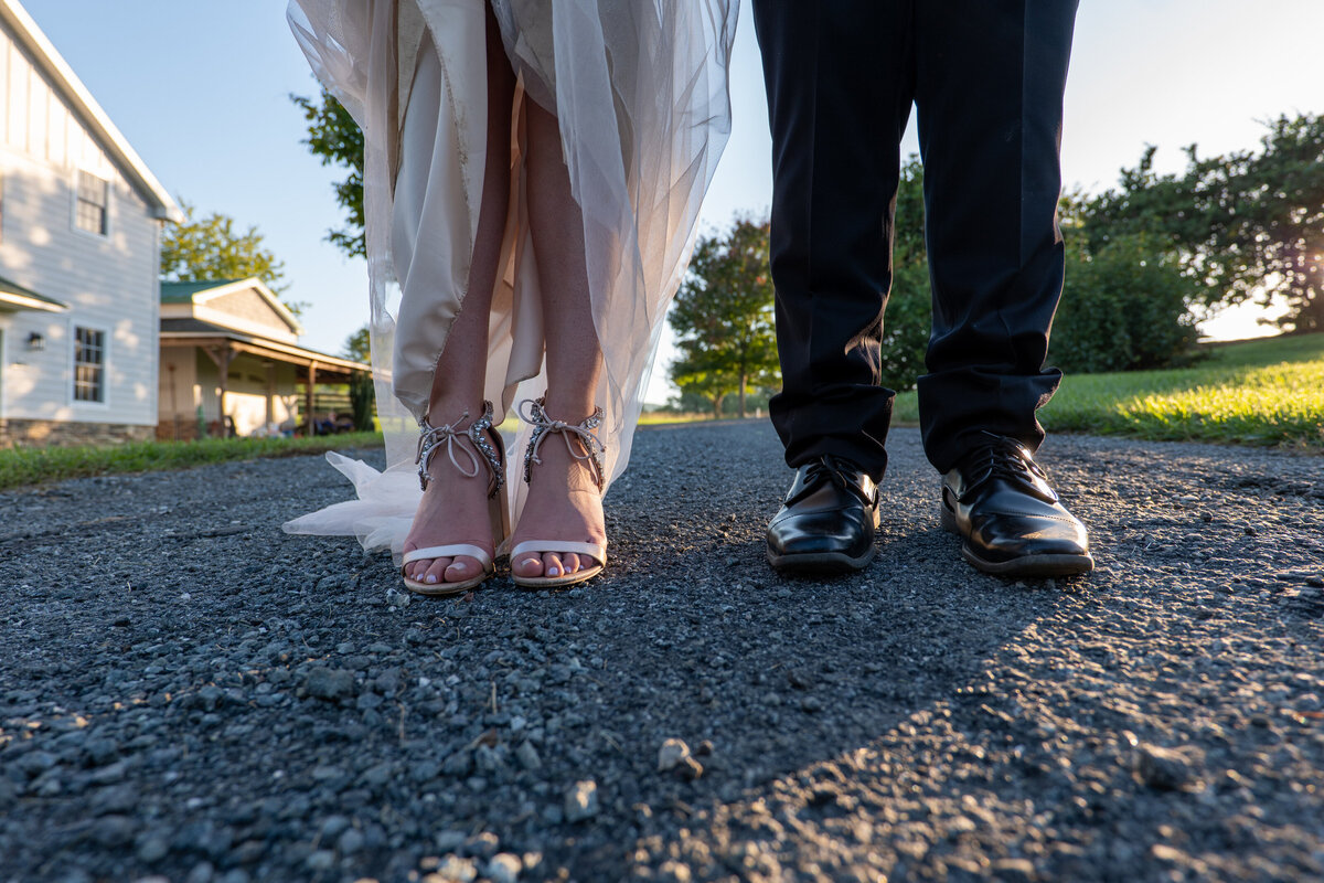 A close up view of a newlywed's shoes on their feet 