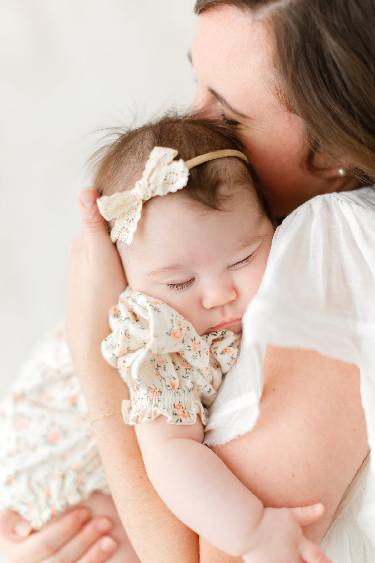 A Baby Photography photo in Northern Virginia of little baby girl asleep in her mama's arms