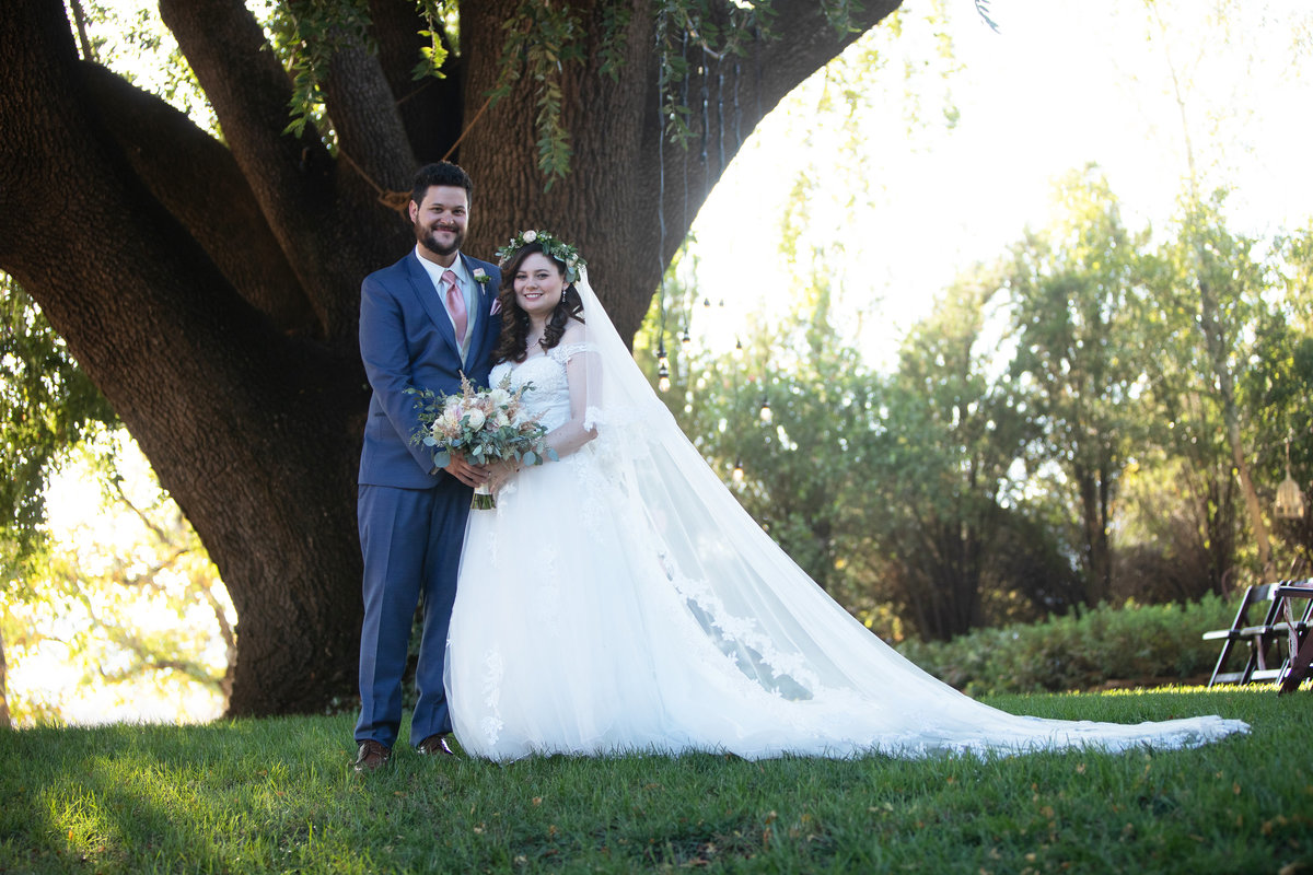 bride and groom under oak tree