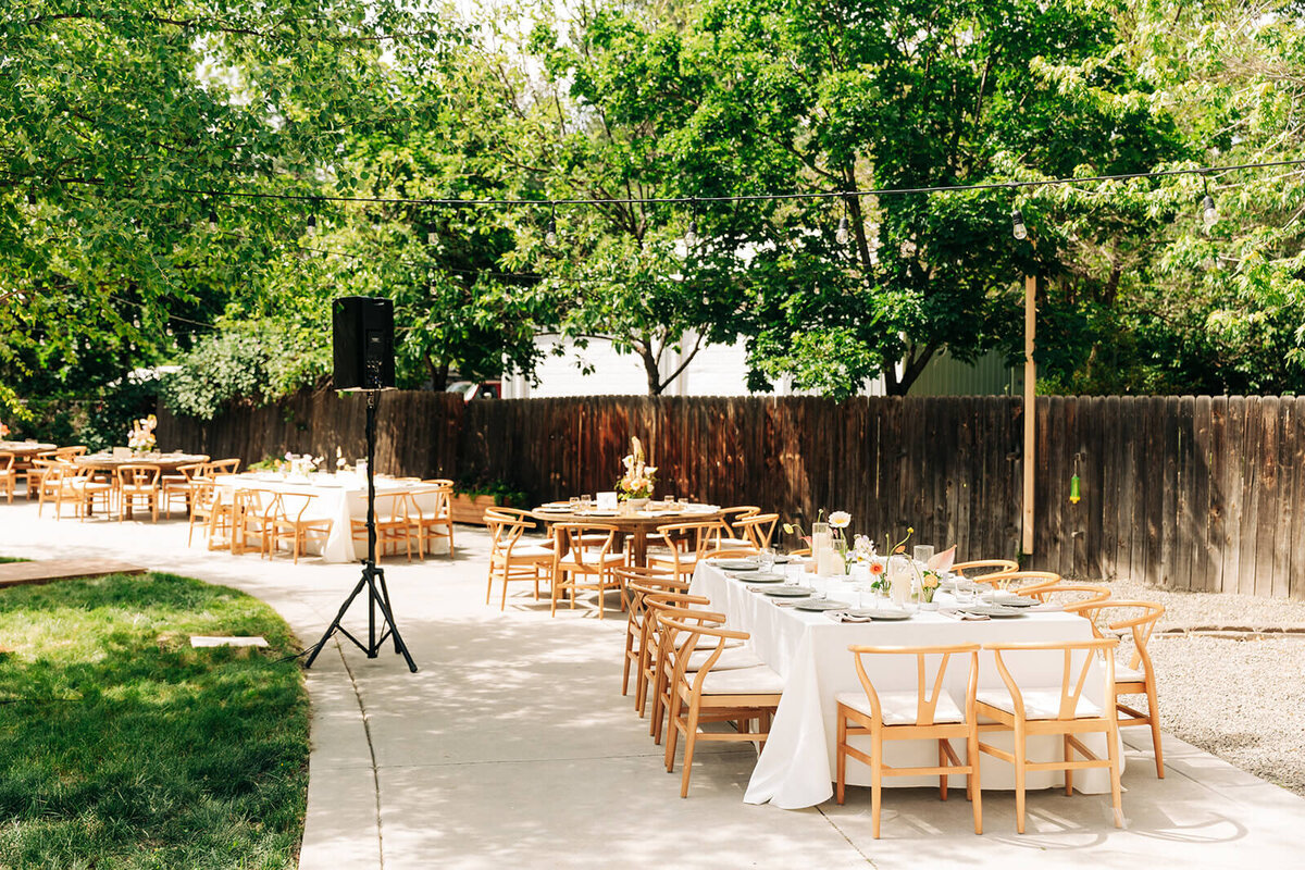 Set tables at a backyard wedding reception.