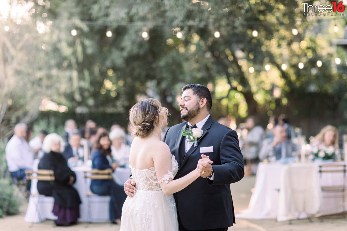 Newly married couple shares their first dance together