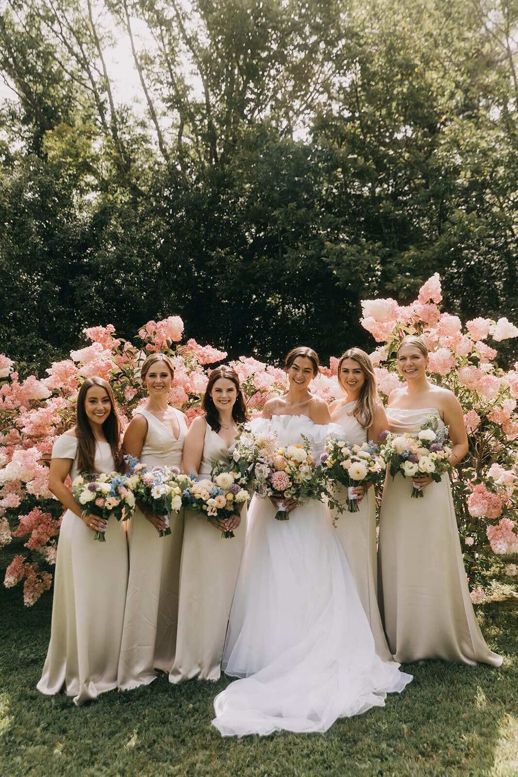 18.bride-bridesmaids-ivory-dresses-holding-colorful-bouquets