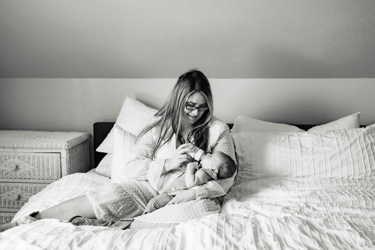 Newborn photography of Mom bottle feeding baby