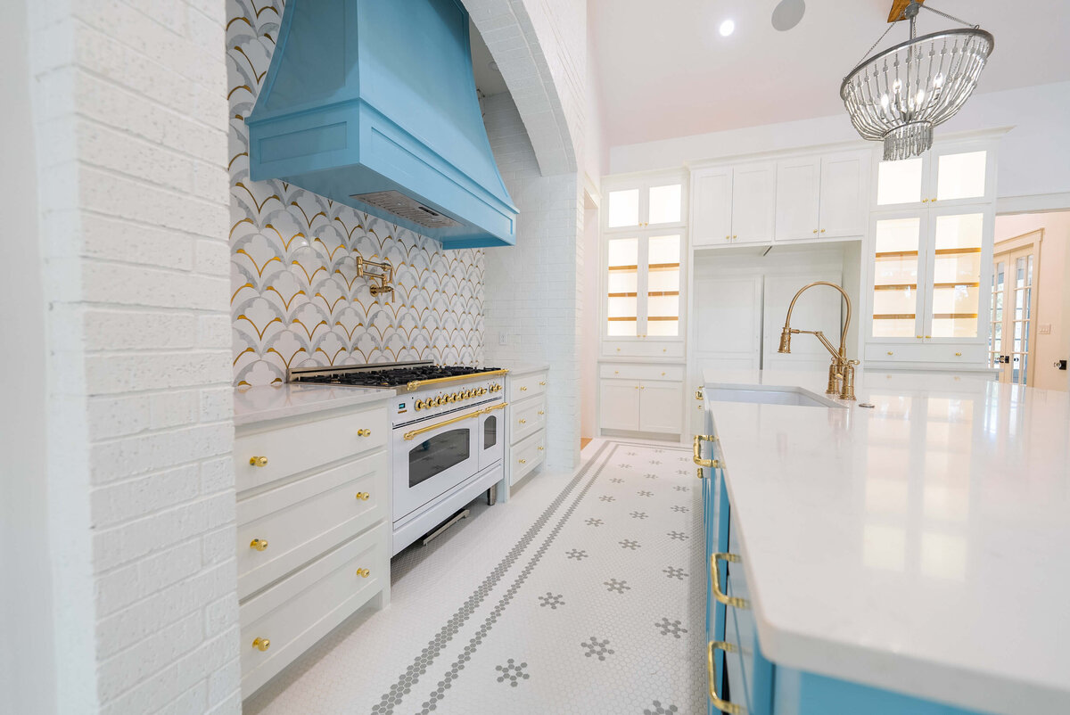 Light blue vent hood in cottage kitchen in north Texas custom home