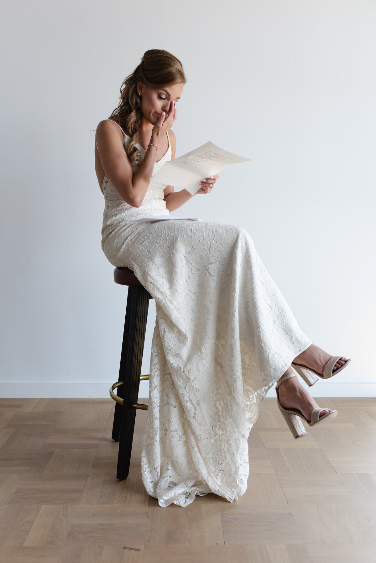 A bride show lots of emotion while ready a letter from her groom
