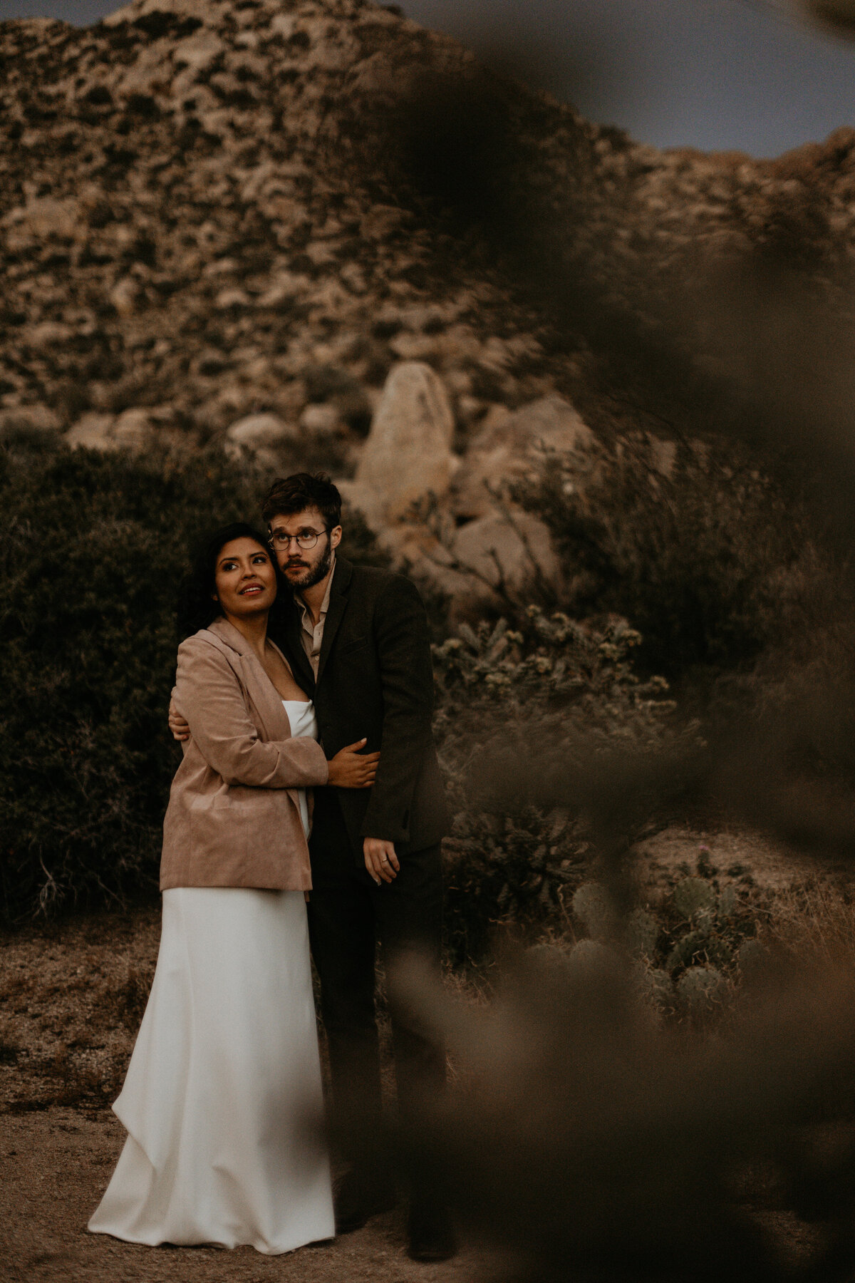 newlyweds holding each other on the Sandia foothills in Albuquerque