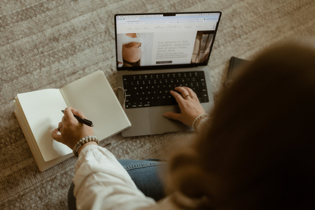 Website designer working on a custom layout for a female photographer
