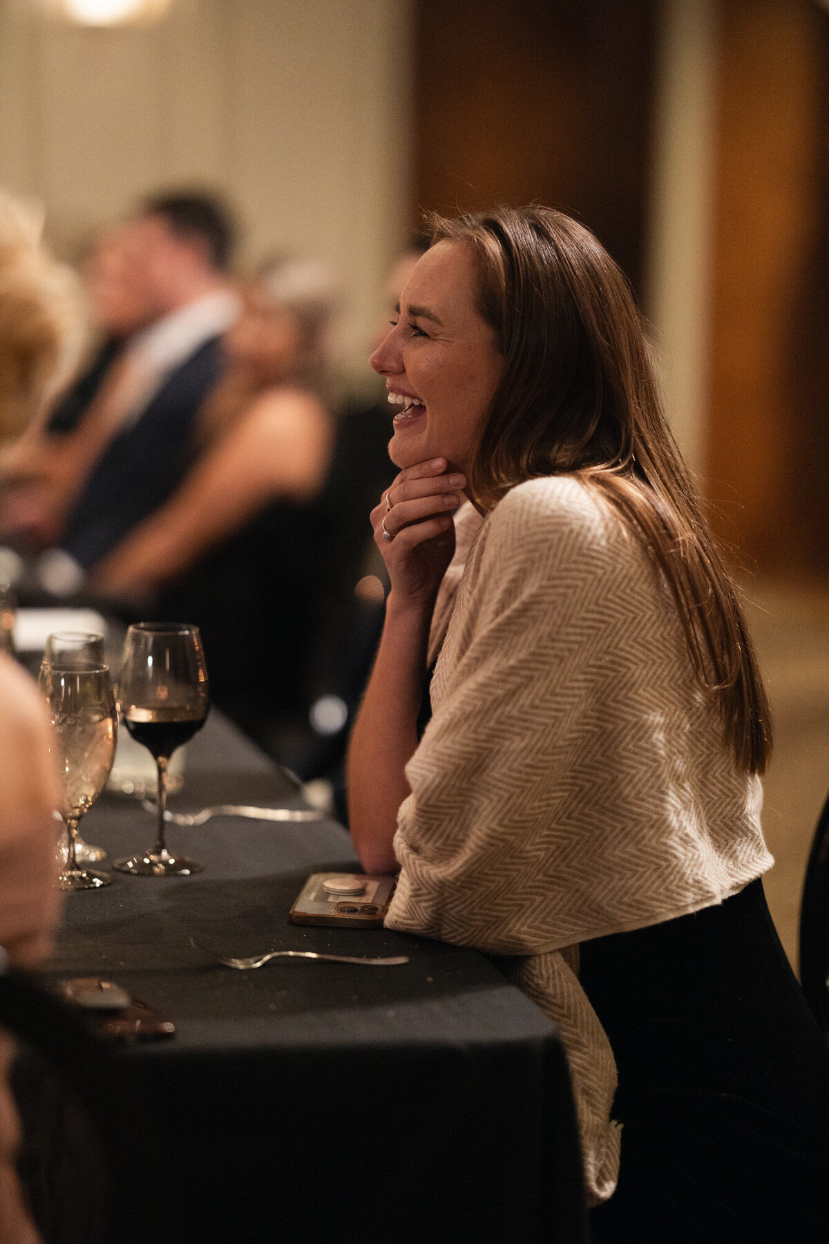 Candid moment of guest laughing during speeches at wedding reception in Paradise Valley, Arizona