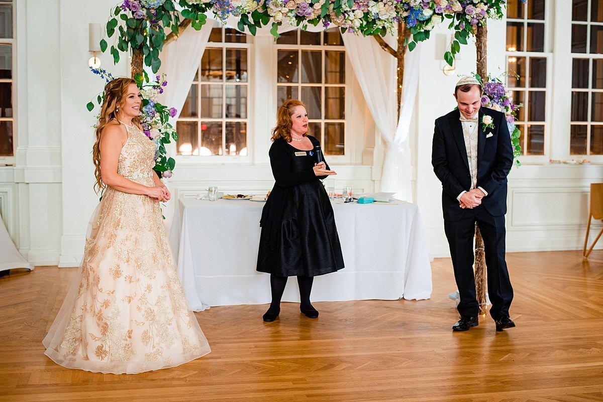 Wedding planner with Weddings & Events by Raina assist guests in special wedding dance for Jewish Wedding. Wedding planner teaches the hora to wedding guests at Jewish Wedding.