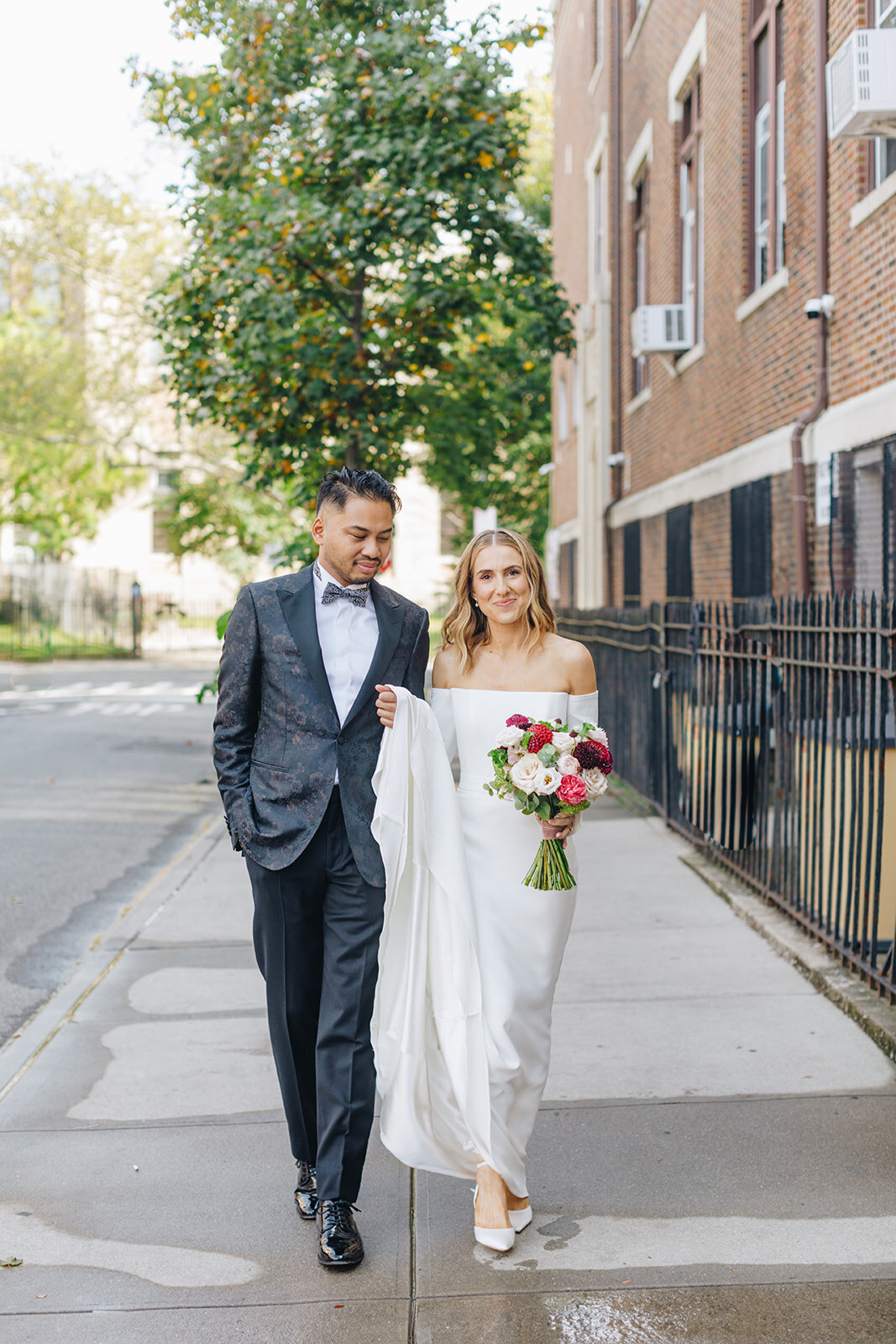 portrait of bride and groom walking outside the brooklyn winery