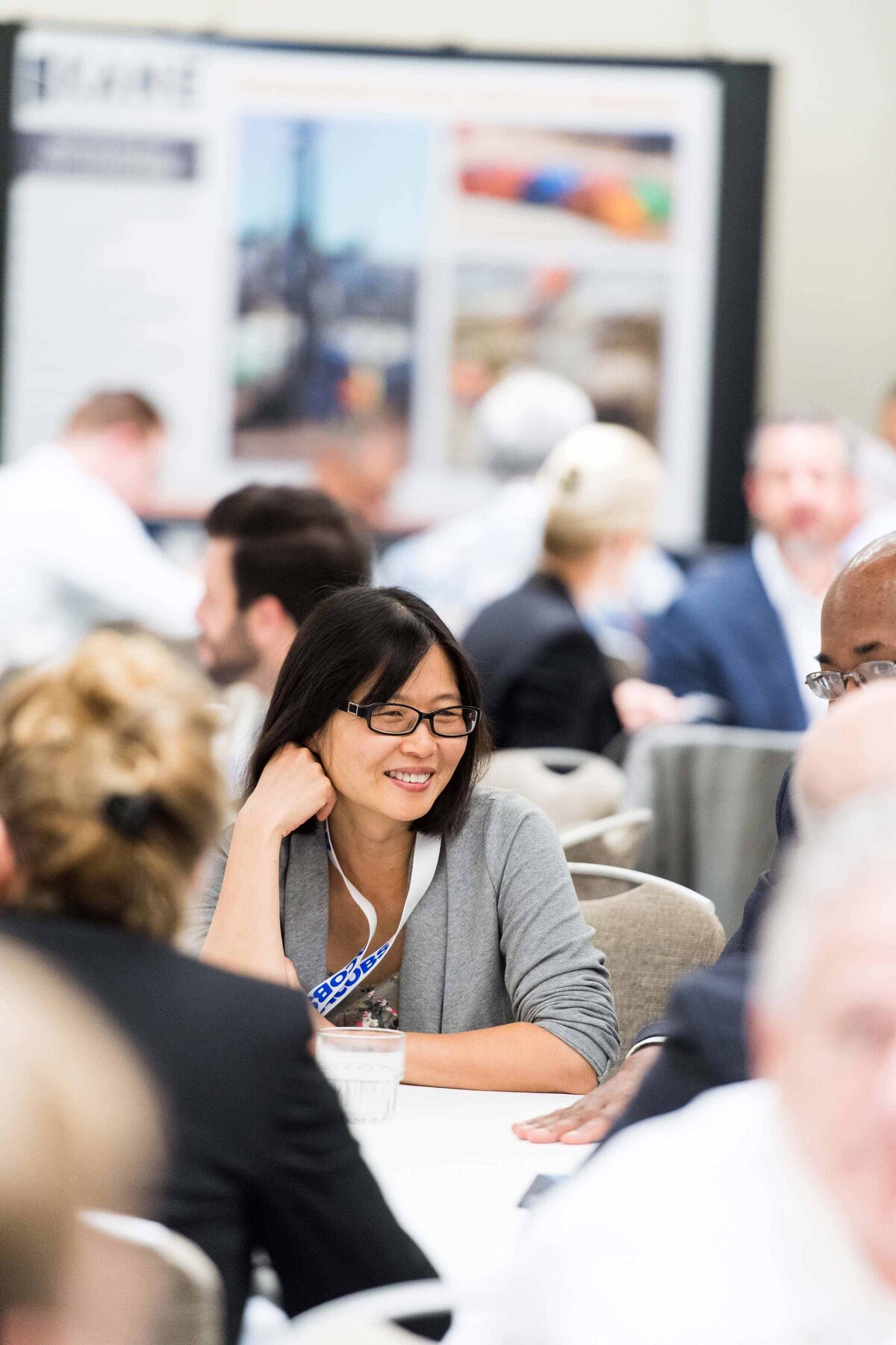 Women smiling at table with business people