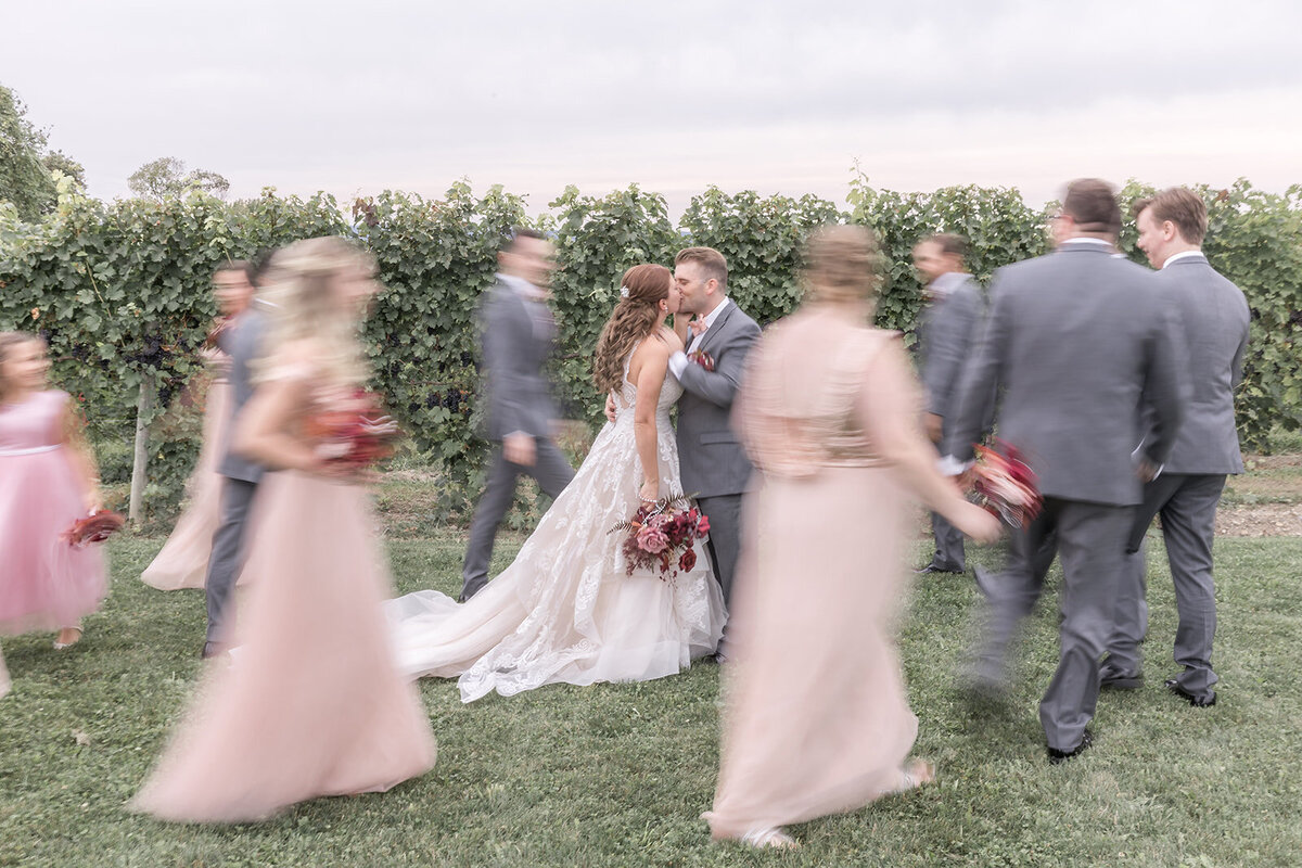 Detroit Michigan wedding couple kissing surrounded by the bridal party