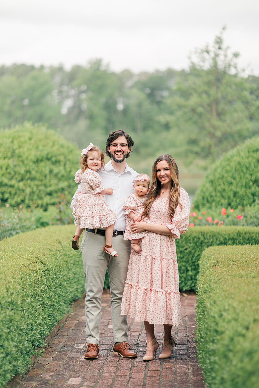 Rose garden portraits of young girls and parents