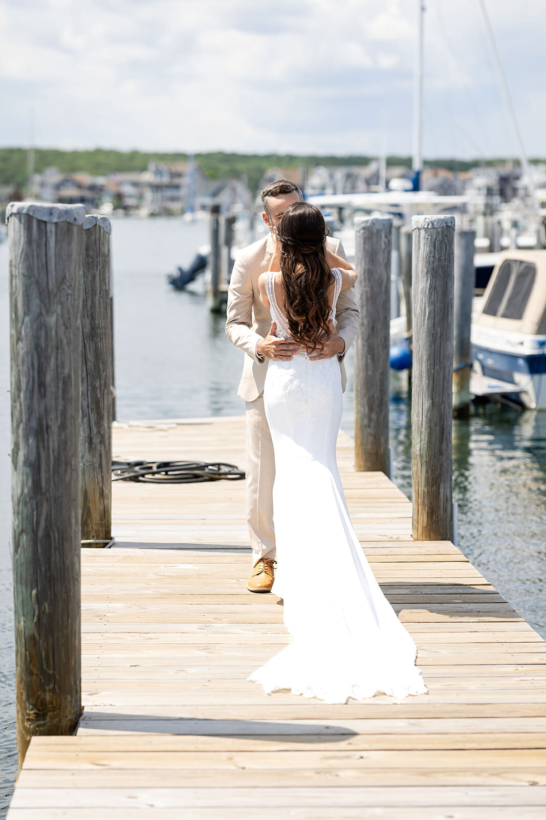 A bride and groom kissing on a dock