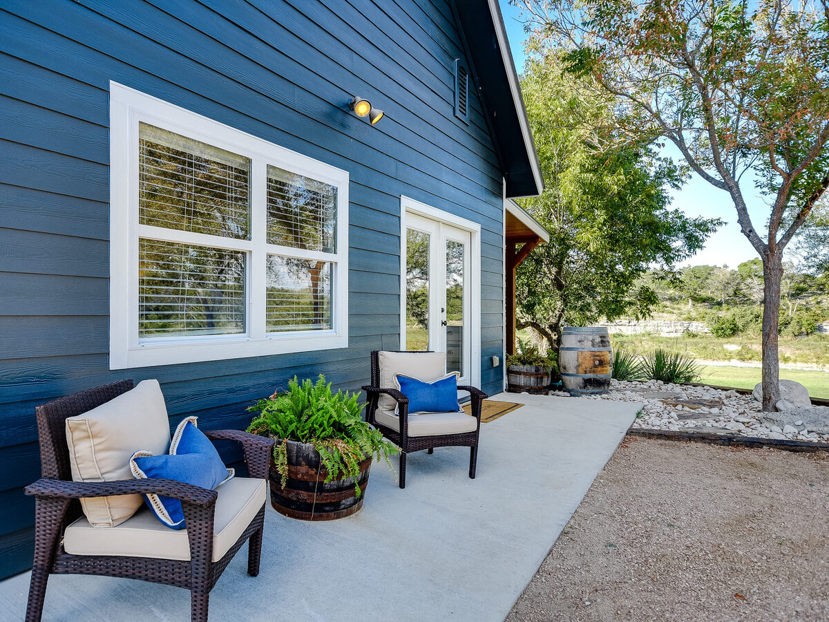 barn porch with blue exterior and cream seating