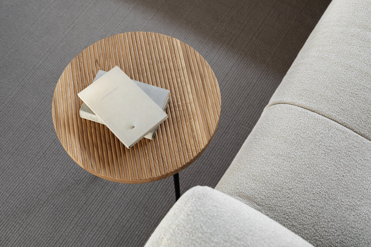 kaboompics_wooden-fluted-table-books-light-beige-sofa-oak-boucle-25045