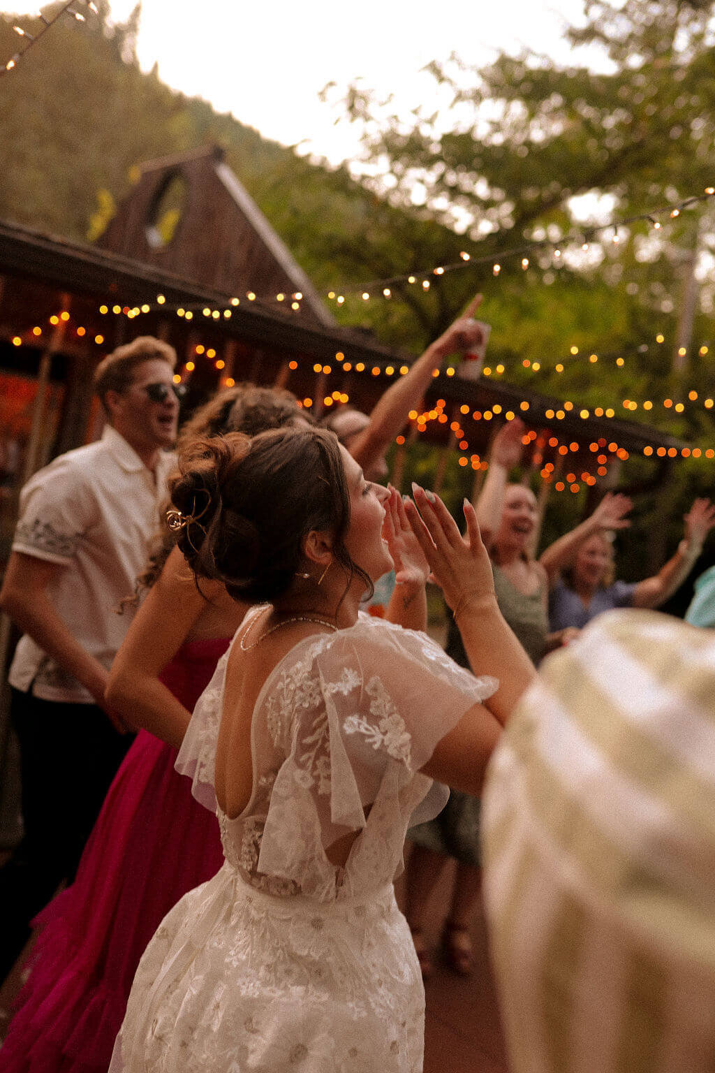 A bride celebrating at her outdoor garden wedding planned by Birdie June Events.