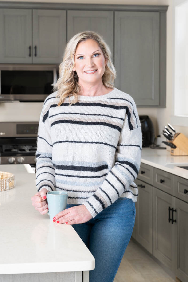 business owner is drinking coffee posing for a branding photoshoot