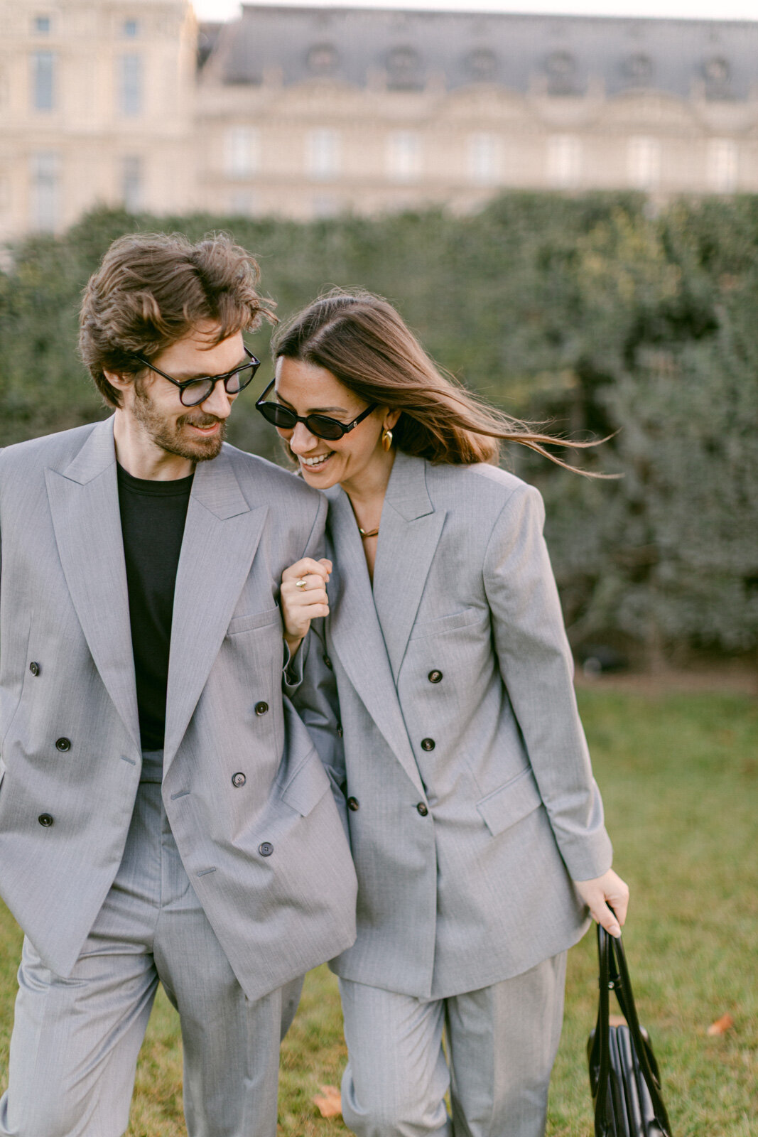 Engagement session at the Tuileries and Louvre in Paris, with a couple walking through the gardens under the morning light.