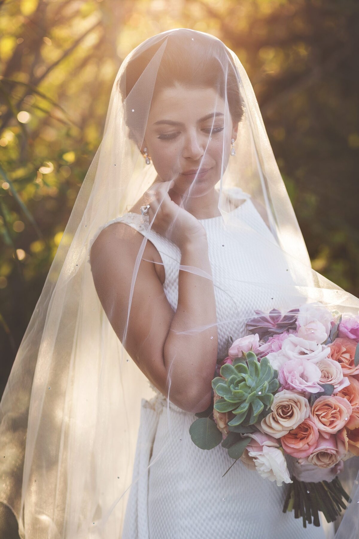 Portrait of bride under veil at wedding in Riviera Maya