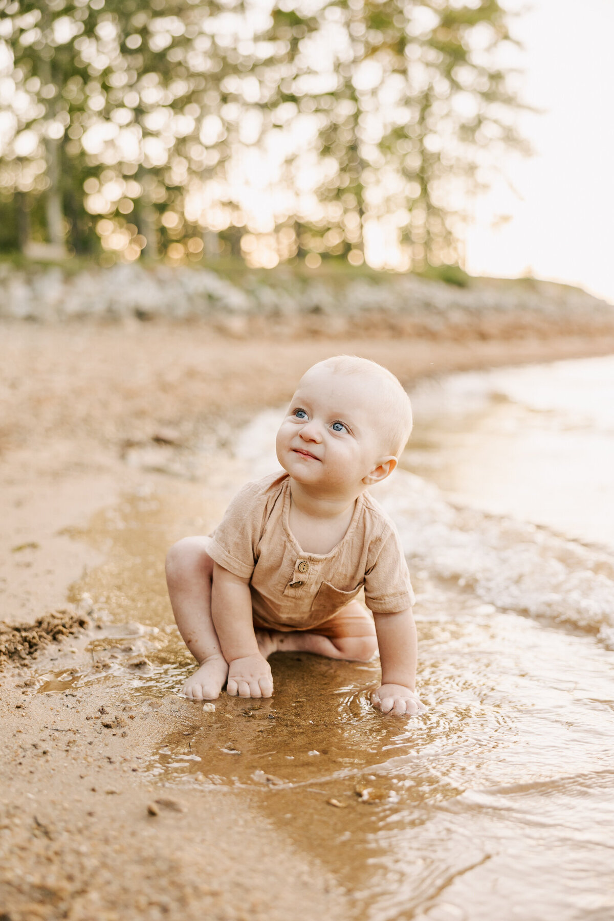 baby boy playing in the water during his aiken sc photography session