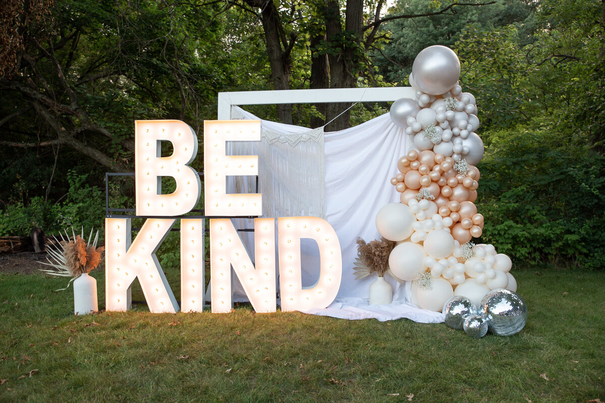 Be Kind giant marquee letters with balloons and disco ball decor