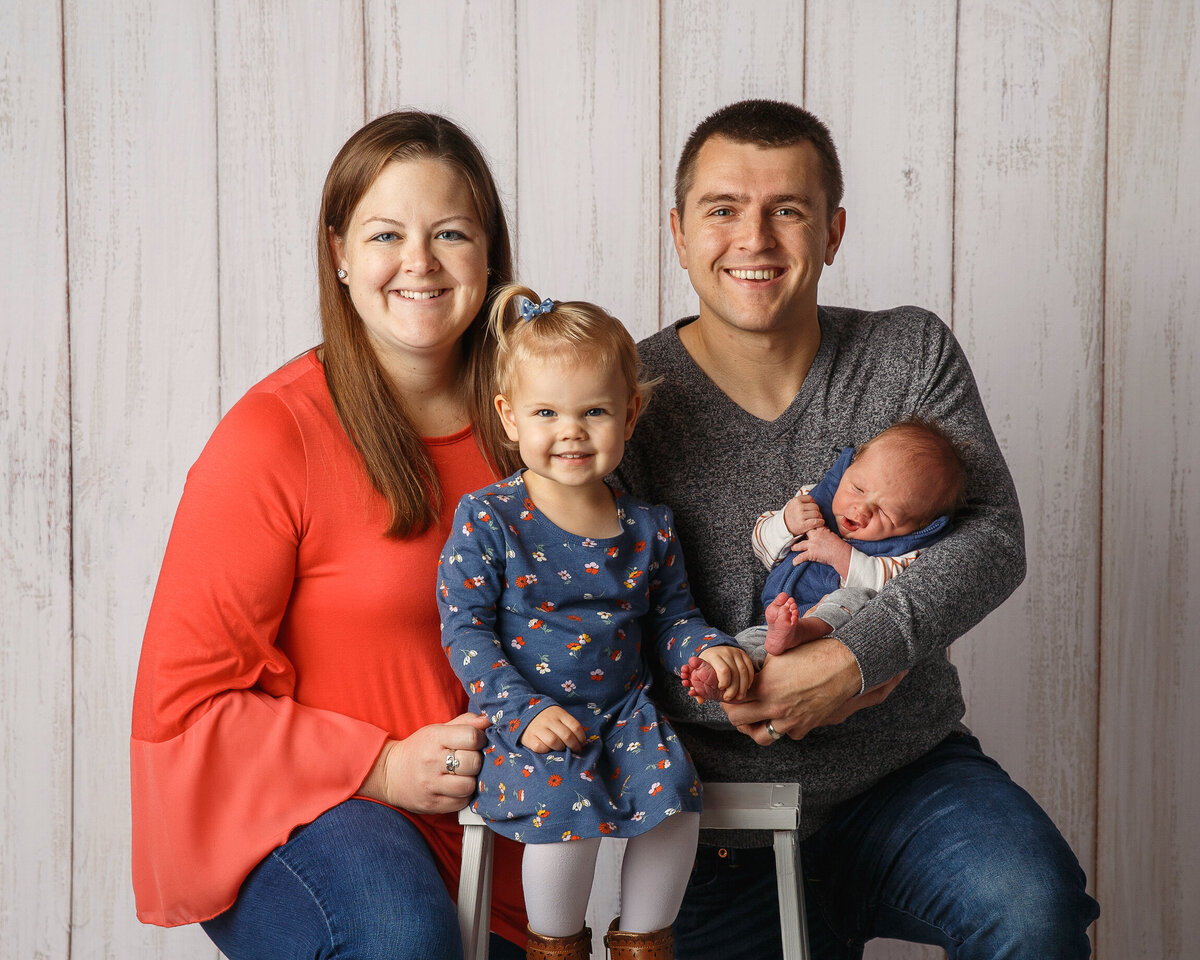 Professional photograph of a family of four including a newborn and toddler