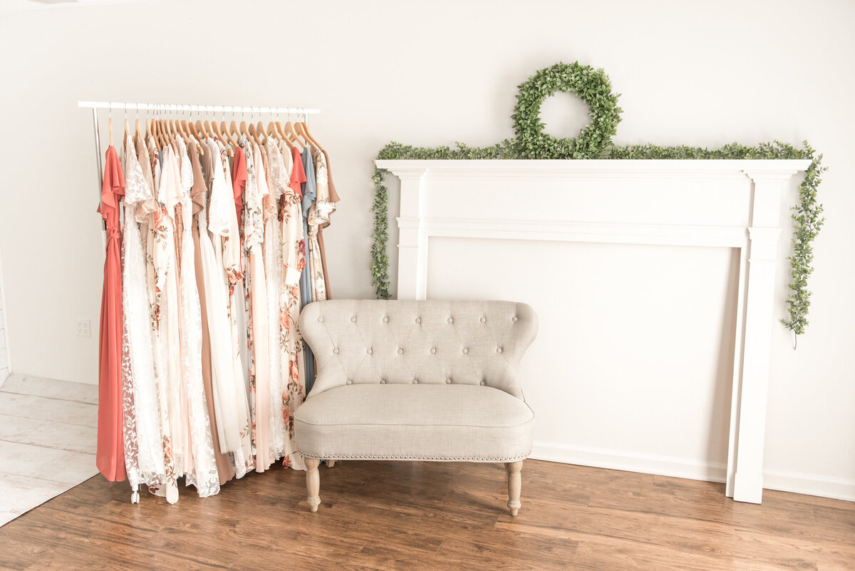 Image of the inside of a photography studio with couch, Client Closet dresses pictured