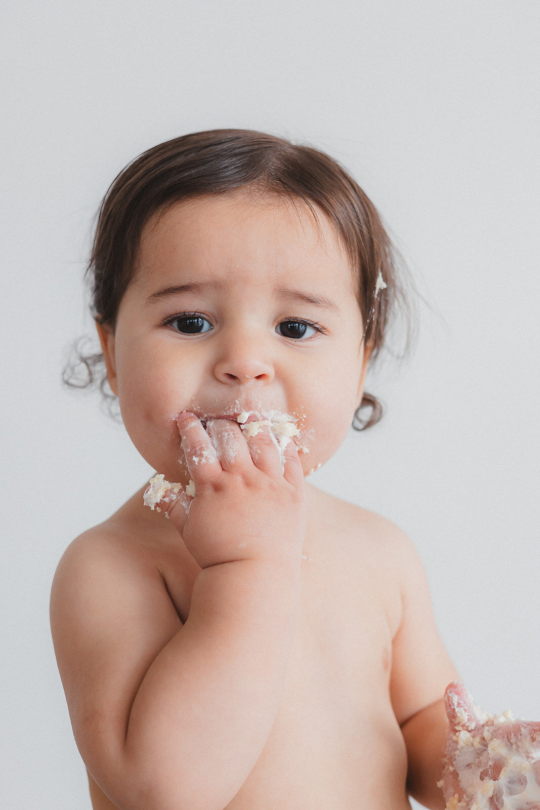 A kid eats cake.