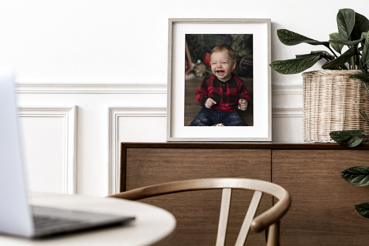 framed photo of one year old boy laughing for cake smash