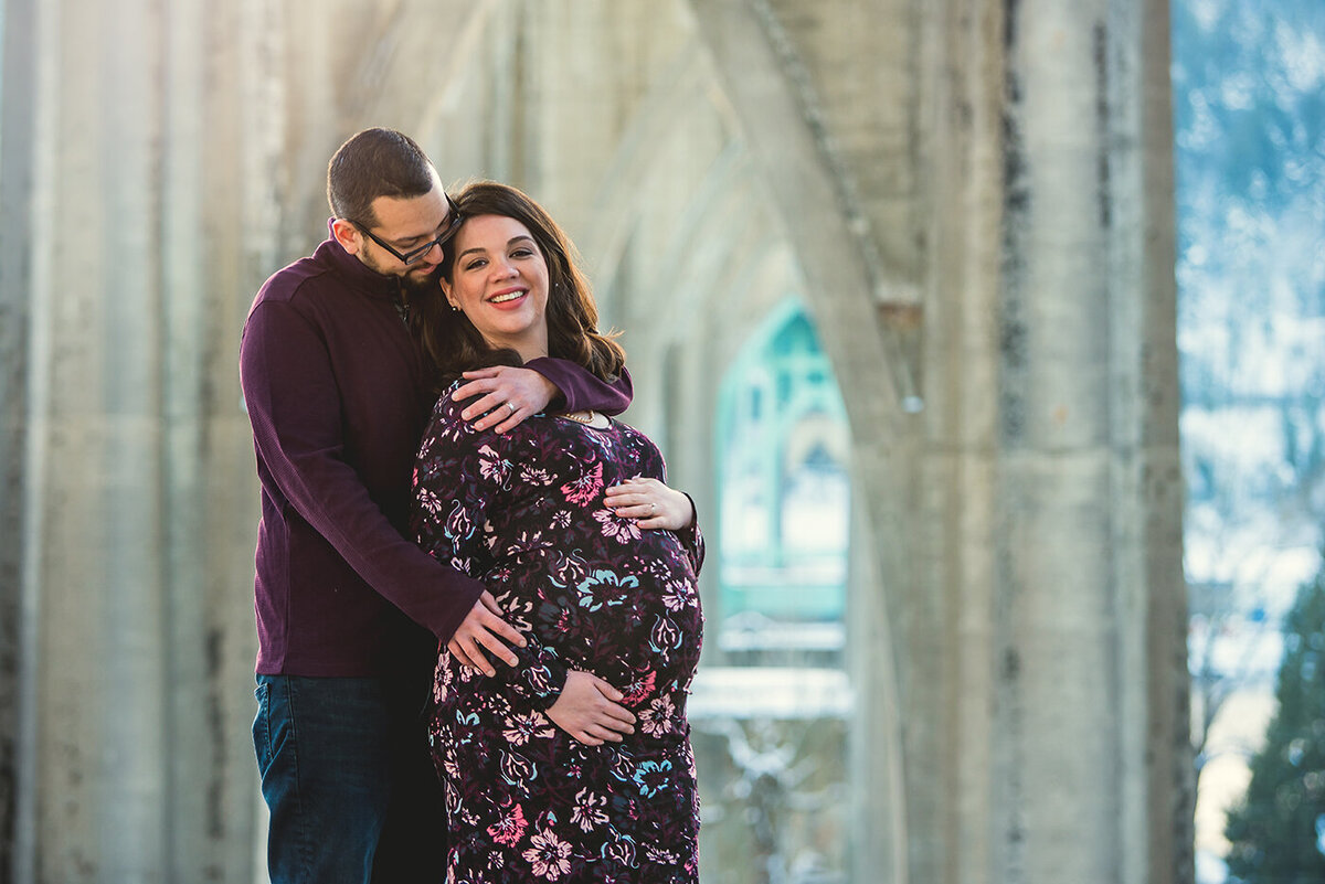 pregnant couple under bridge