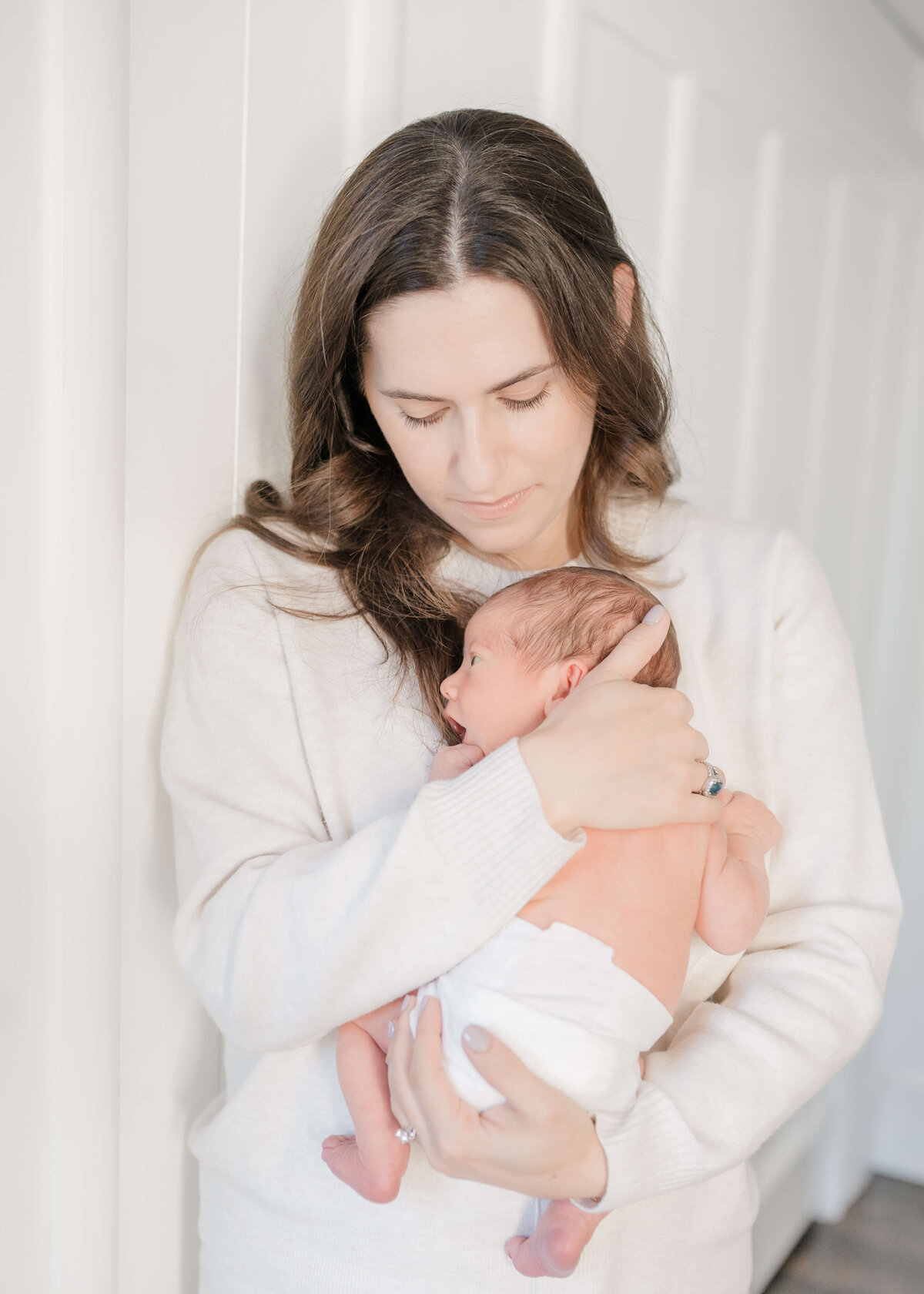 Natural newborn portraits in Pleasanton home using soft, neutral tones.