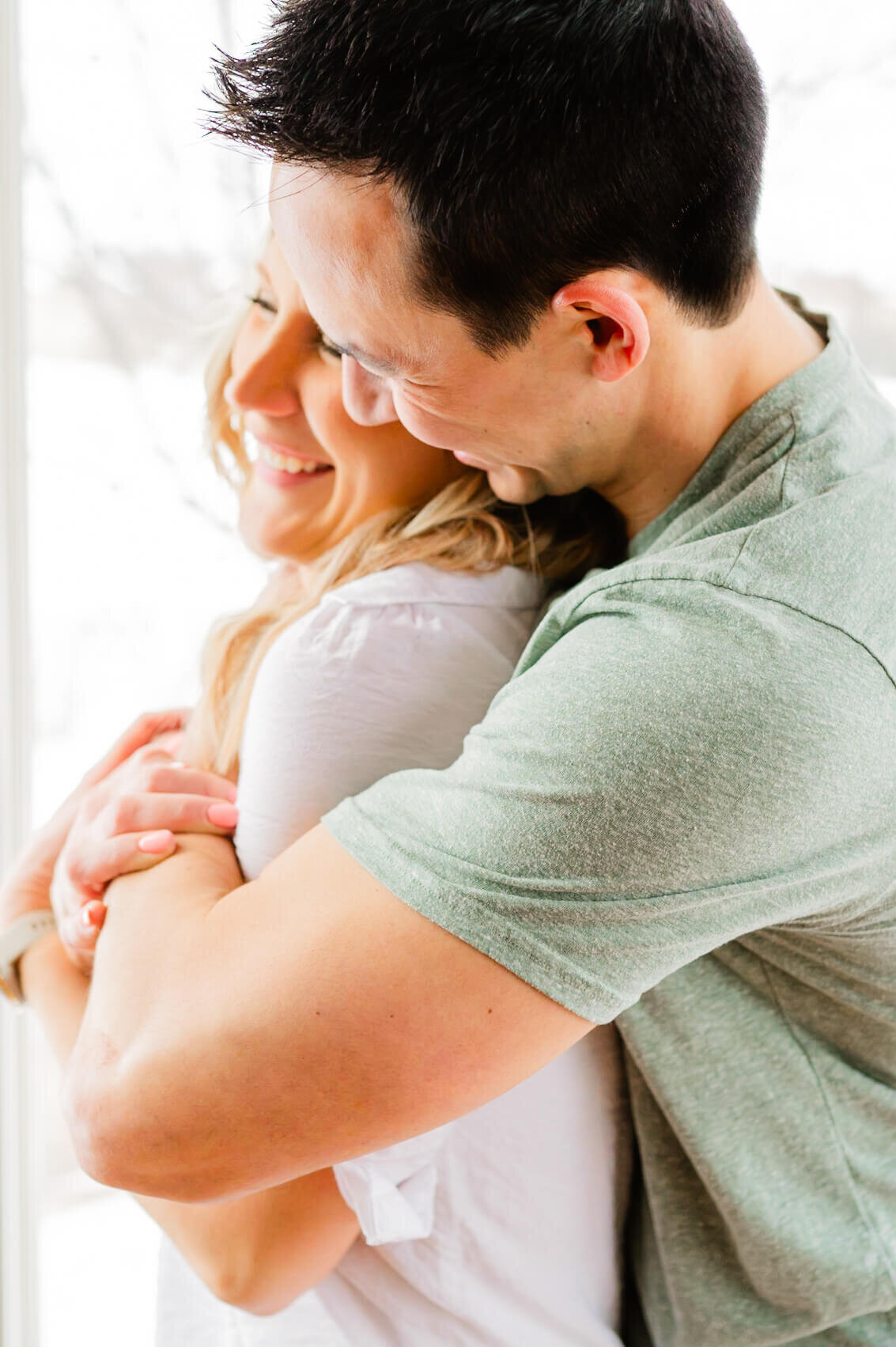 Man embraces woman in kitchen at a couples session in Sugar Grove, IL.