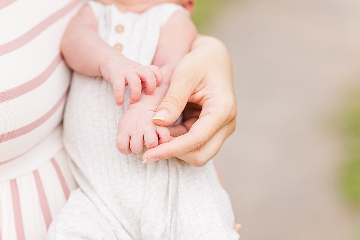 baby hands  during outdoor newborn photo session with Sara Sniderman Photography at Oak Grove Park in Millis Massachusetts