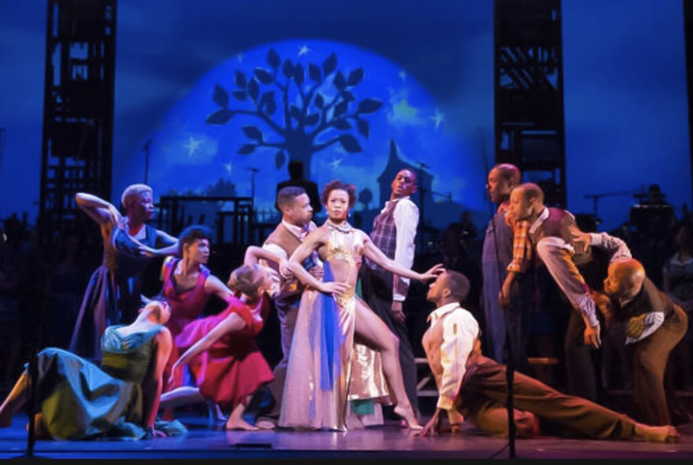 cast of performers on stage