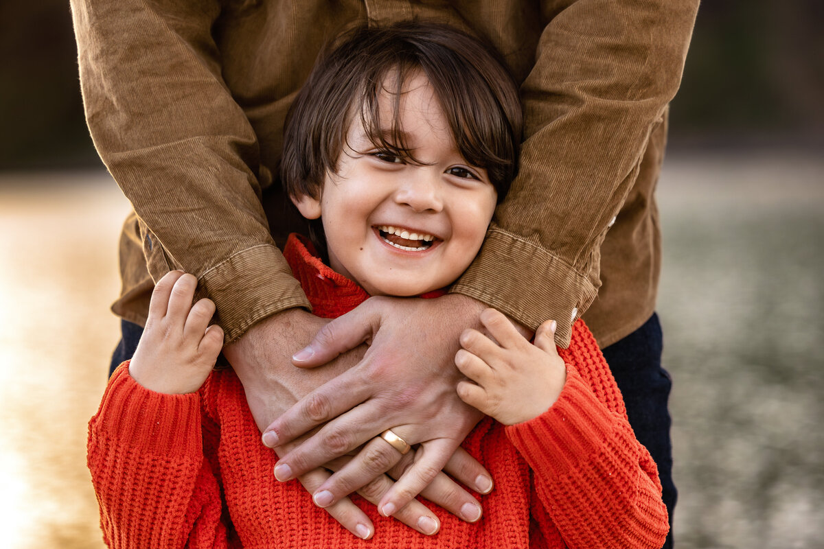 son-with-fathers-hands-rattlensake-lake