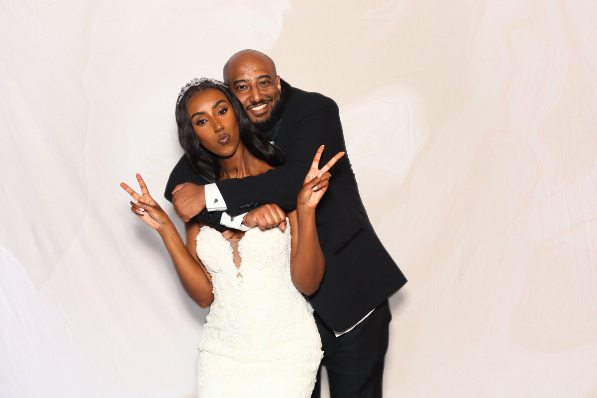 Wedding couple taking a picture in their photo booth at Brookstreet Hotel in Ottawa