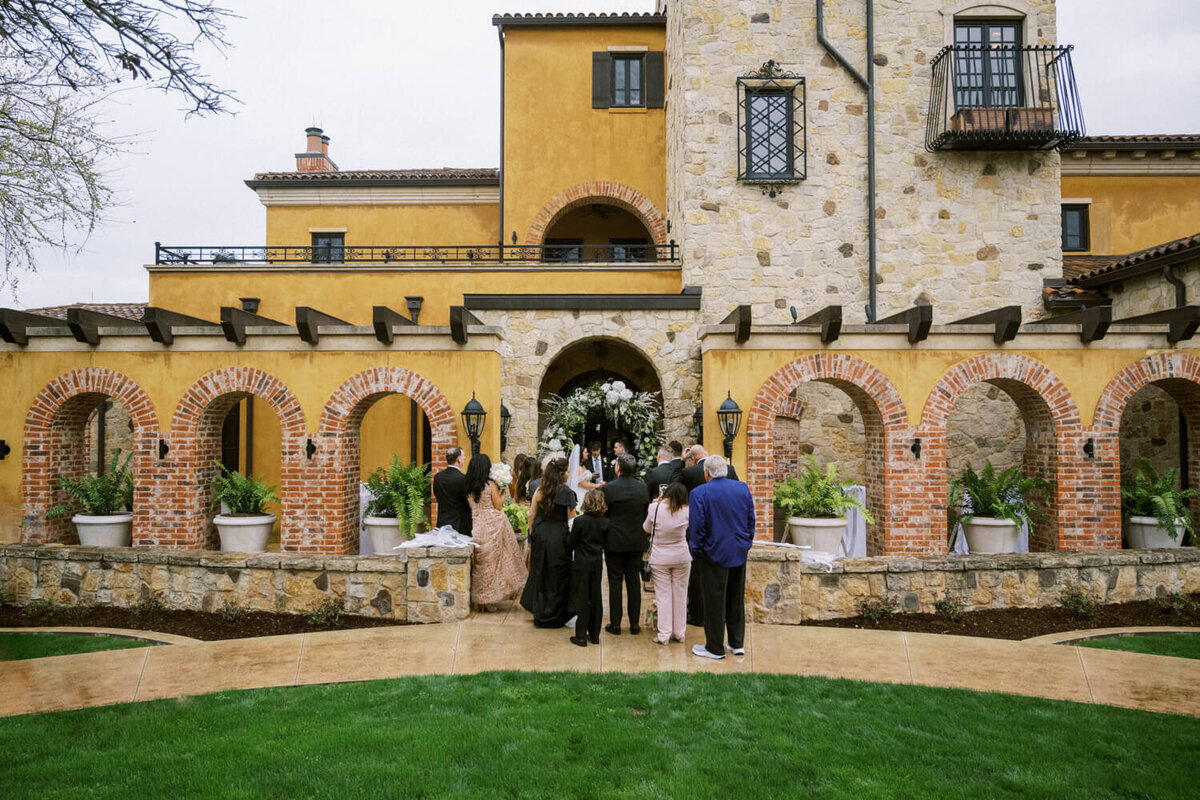 guests-gathered-in-front-of-home-wedding