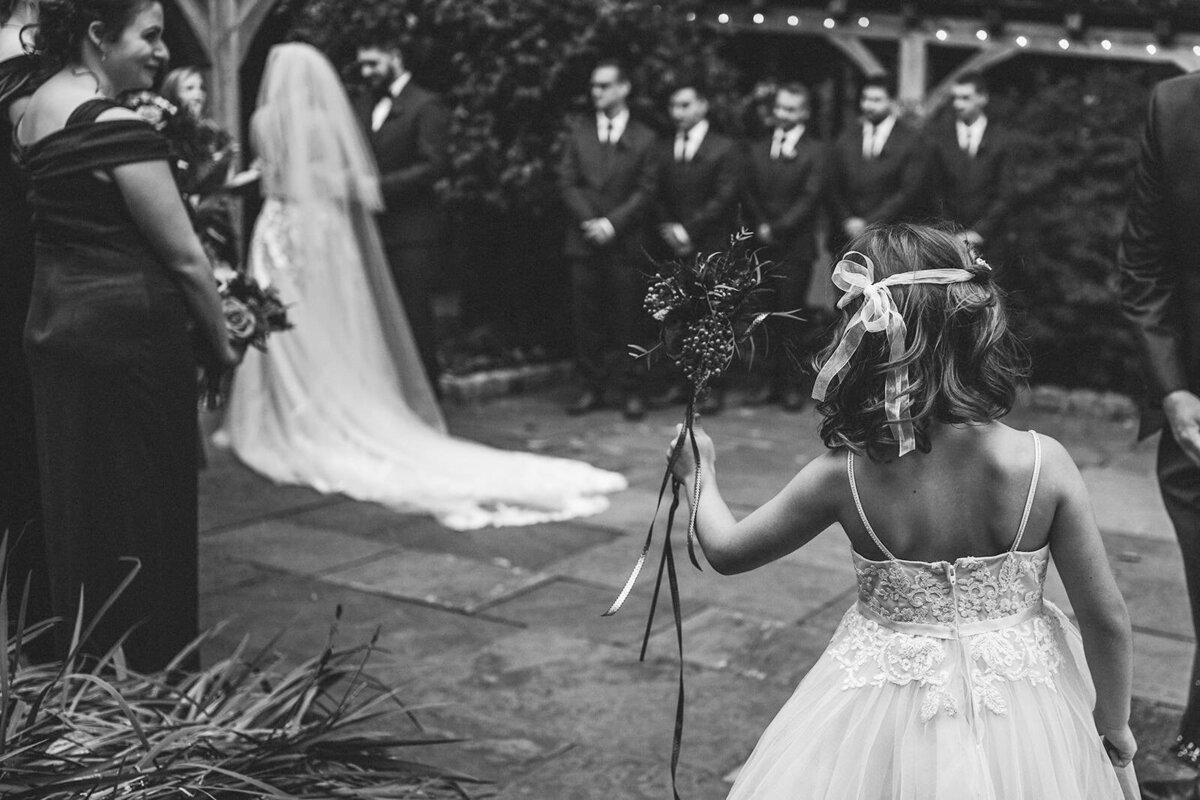 A small child looking on at a wedding ceremony 