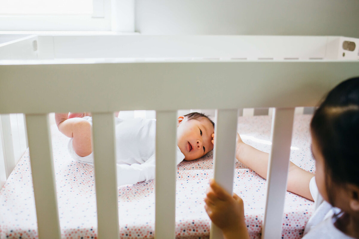 Acton Newborn  Lifestyle Photographer siblings in crib-1