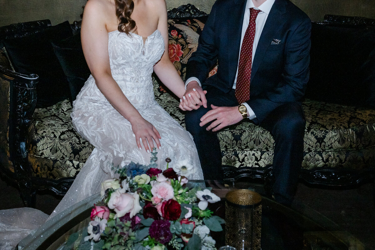 bride and groom seated at the ruins landmark event company venue