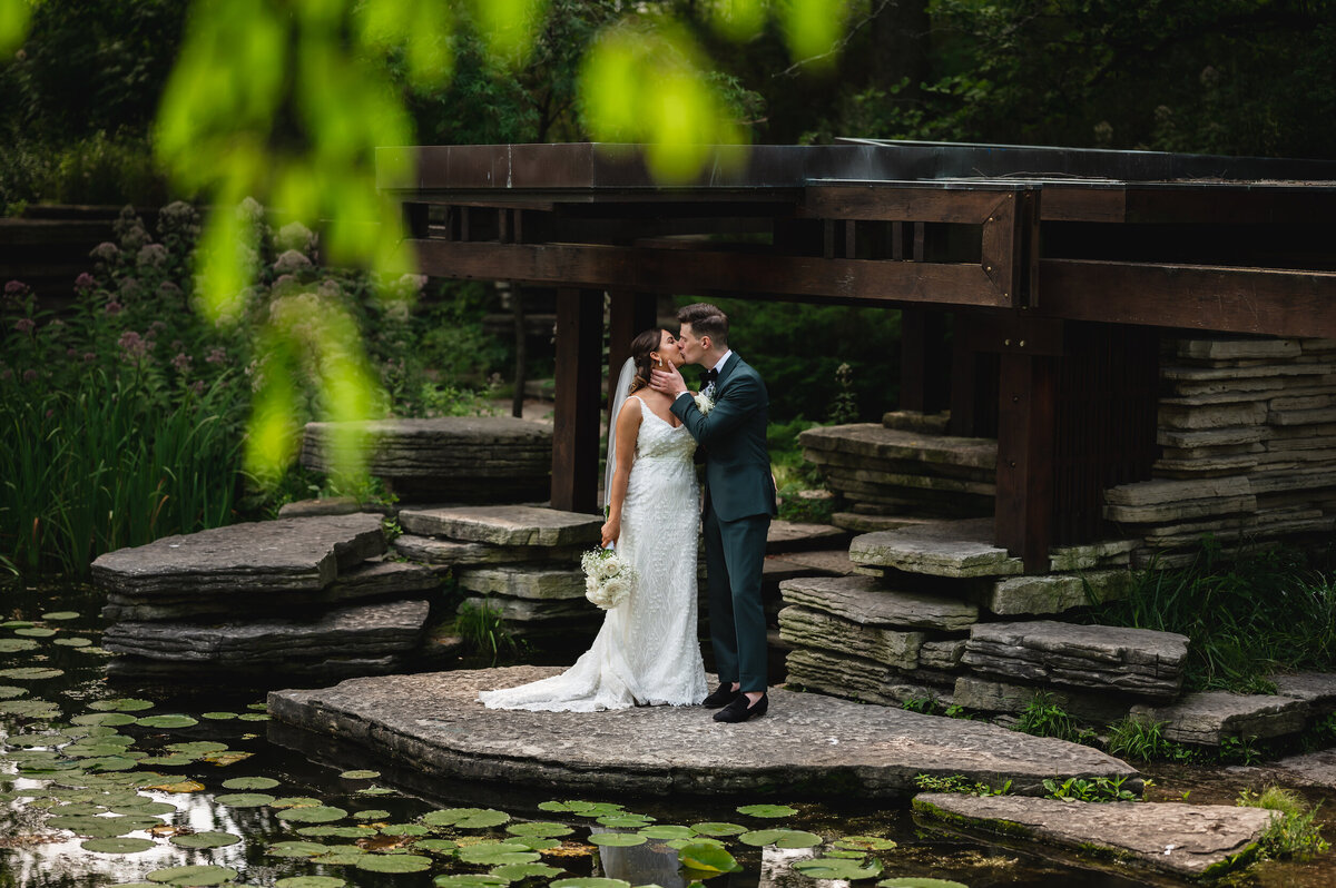 Bride any groom kiss at the Alfred Caldwell Lily Pool