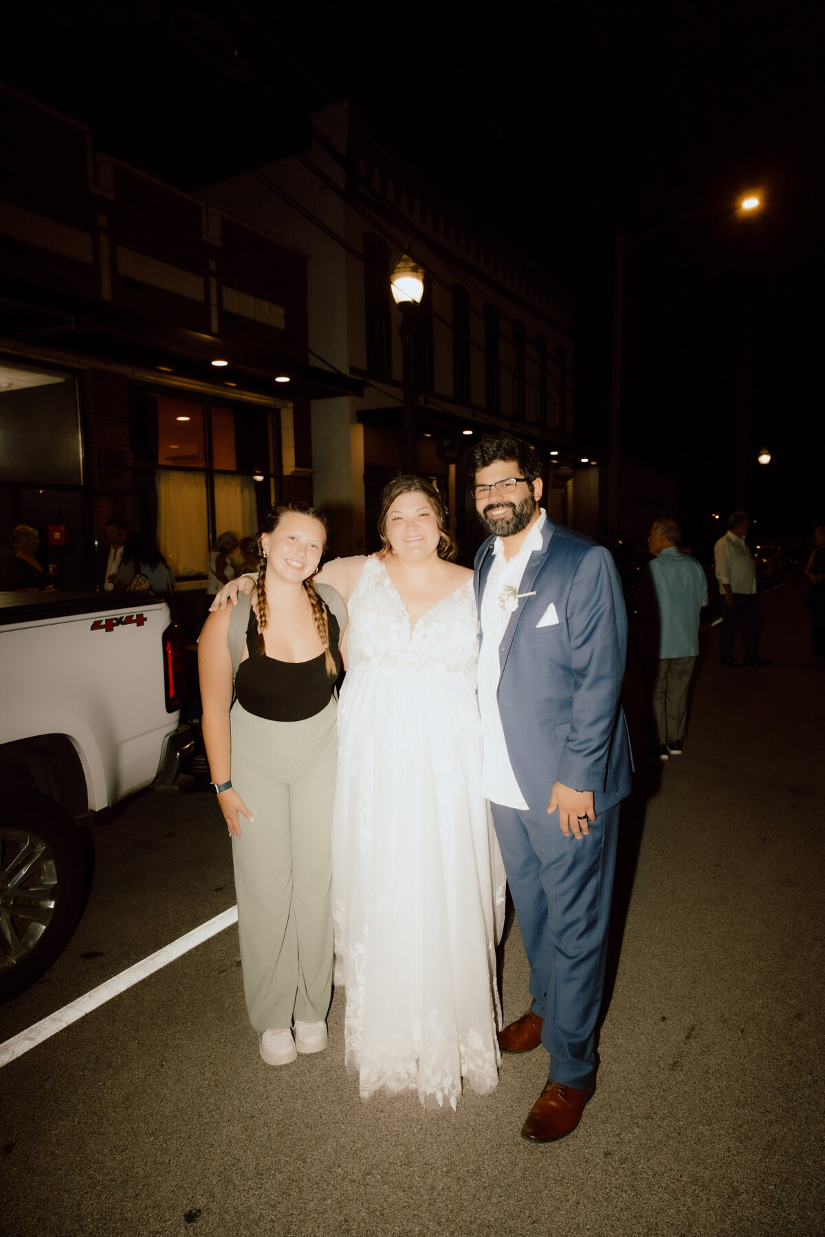 wedding photographer posing with her wedding couple at missouri wedding