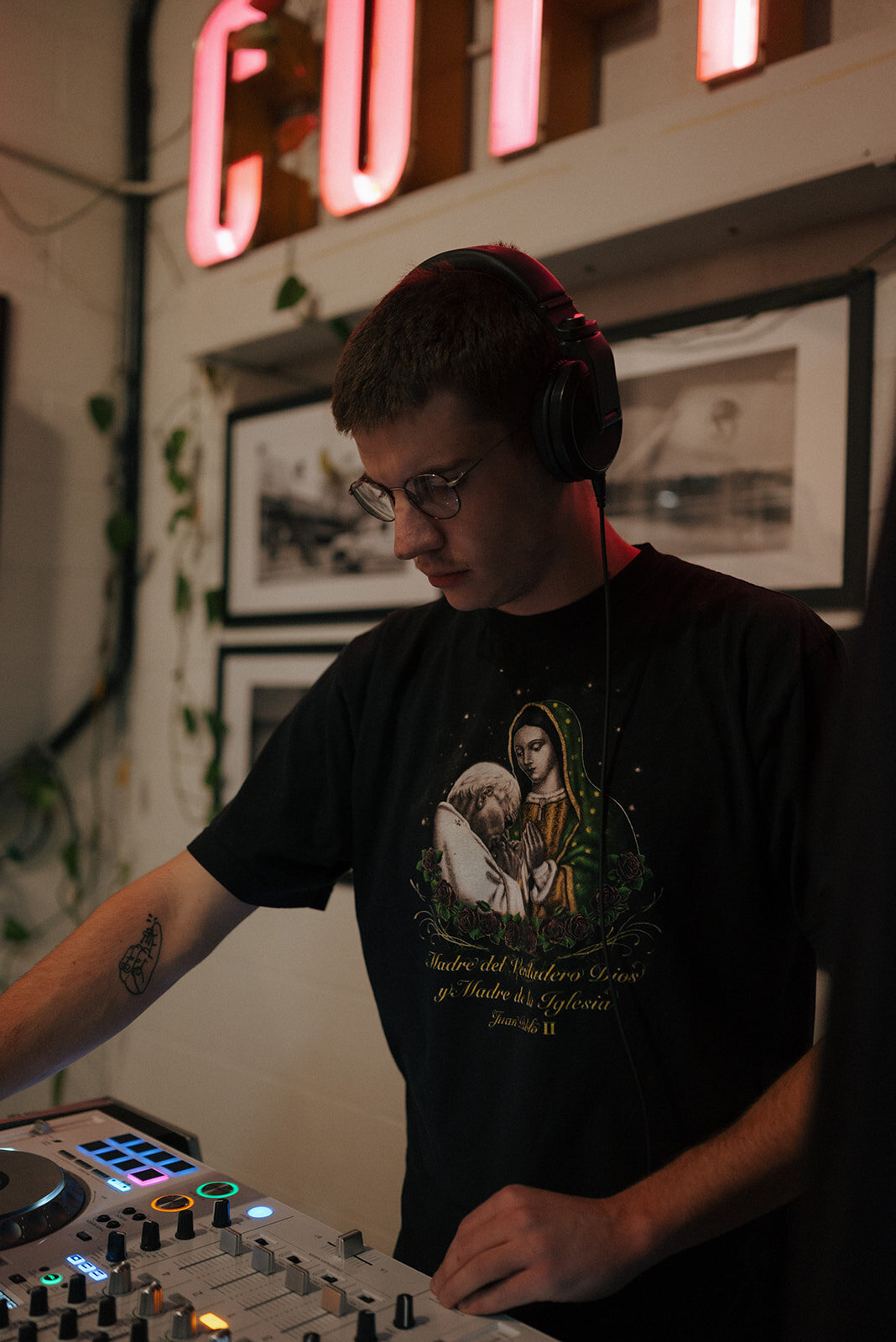 A DJ stands at his soundboard at a vow renewal.
