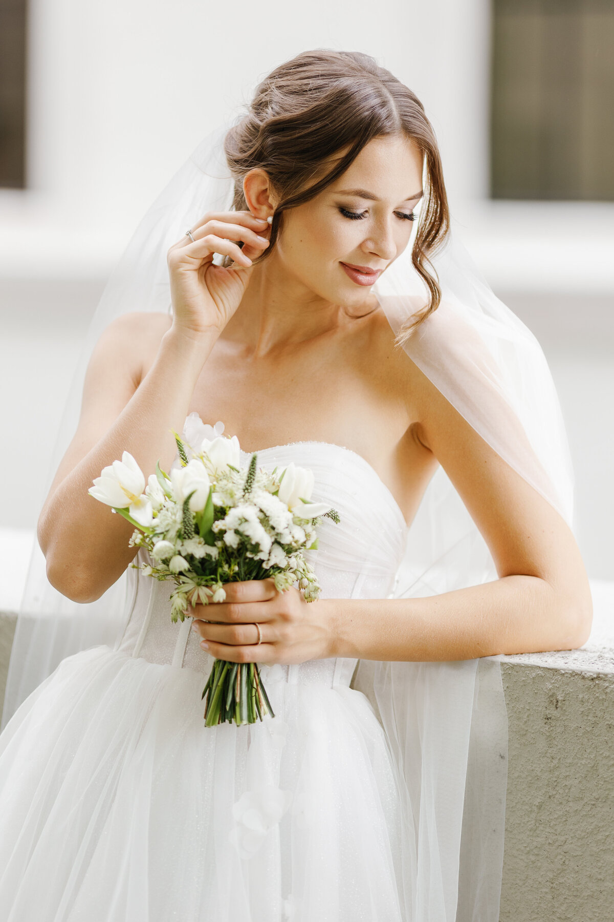 Stunning portrait of a bride in her wedding gown holding a bouquet, taken by Claudia Amalia Photography in Miami, Florida.