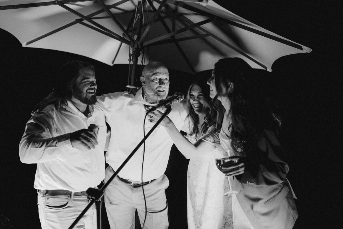 Wedding guests singing into a microphone at Dallenbach Ranch Wedding in Colorado