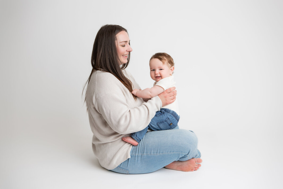 Mom and son on a simple white savage backdrop