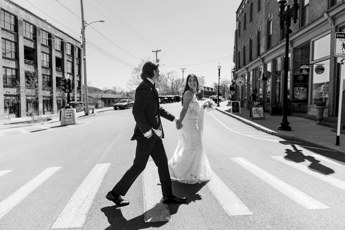 Bride and groom walk across Main Street in Beacon on their Roundhouse wedding day