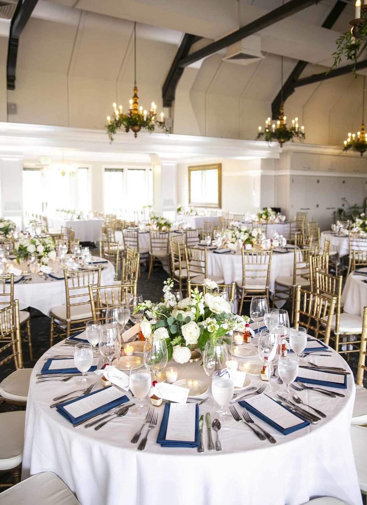 Seattle Country Club wedding with round reception tables and gold Chivari chairs and peony centerpieces